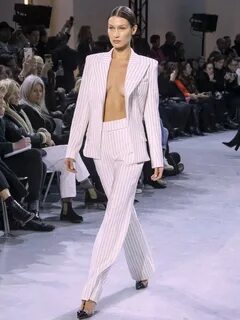 Bella Hadid braless in unbuttoned striped pantsuit for Alexa