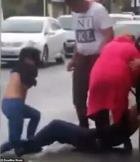 Woman’s top is almost ripped off in vicious brawl with anoth