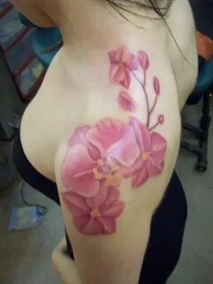 excellent orchids flower watercolor tattoo on girl's shoulde