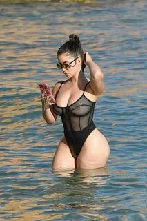 Demi Rose flaunts her jaw-dropping curves in a mesh thong sw