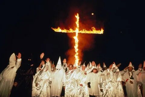 KKK members burning a cross - ABC News (Australian Broadcast