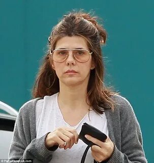 Make-up free Marisa Tomei wears drab cardigan and grungy boy