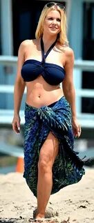 Carrie Keagan shows off her busty figure in a navy bikini fo