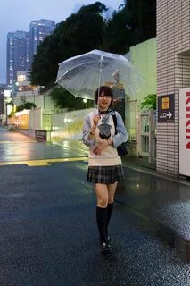 Asian Woman with umbrella on street with colorful lights fre