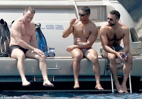 David Furnish shows off his muscles as he enjoys yacht trip 