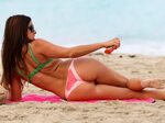 claudia_romani_in_a_watermelon_colored_bikini_at_the_beach_i