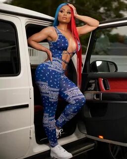 Blac Chyna Sizzles In Red Latex Dress Laying On Classic Car