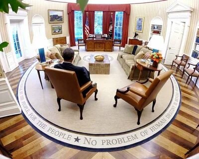 BARACK OBAMA READS BRIEFING MATERIAL IN THE OVAL OFFICE - 8X