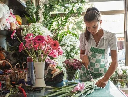 Florist Working In Her Flower Shop. by Mosuno