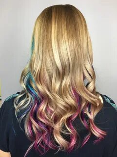 Pink, purple, and blue (teal) peekaboo highlights under blon
