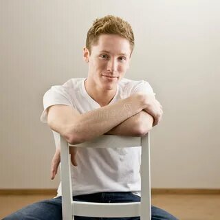 Young Man Sitting Backwards in Chair Stock Image - Image of 