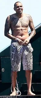 Shirtless Chris Brown sports heavier frame in St. Tropez wit
