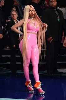 Nicki Minaj busty in a plunging pink latex catsuit at the 20
