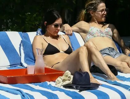 Courteney Cox soaking some sun in a tiny black bikini at the