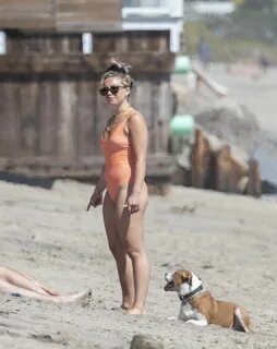 Florence Pugh In tight orange swimsuit on the beach in Malib