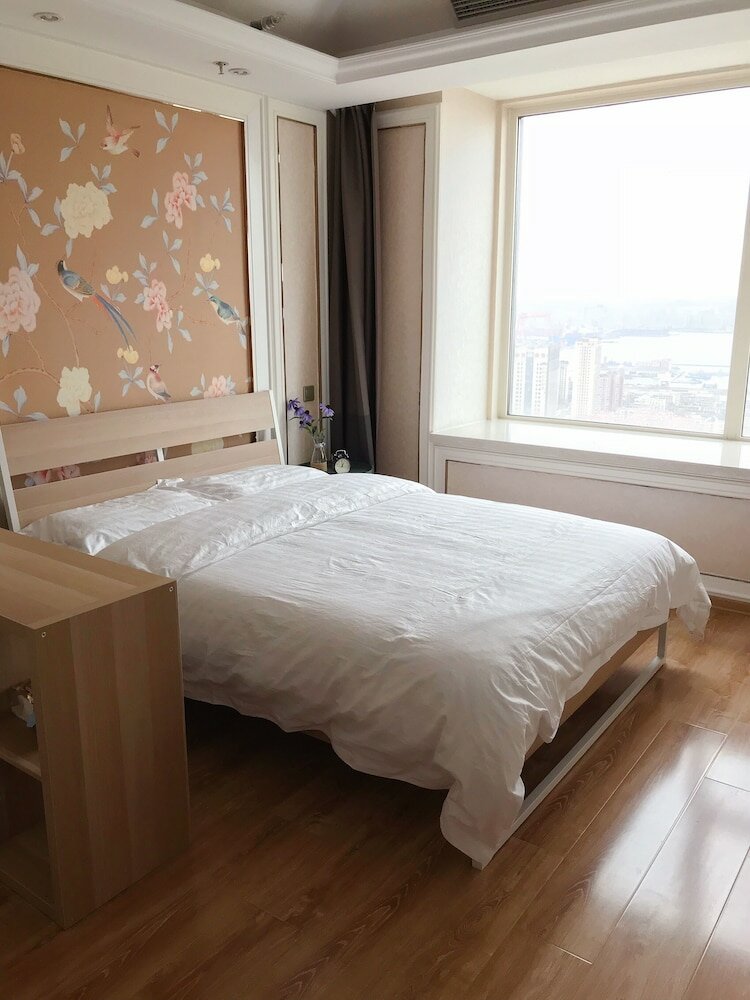 Фото Dalian Xuanya Apartment