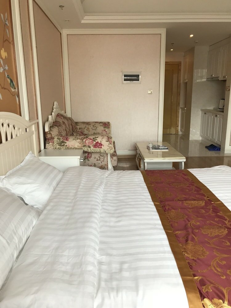 Фото Dalian Xuanya Apartment