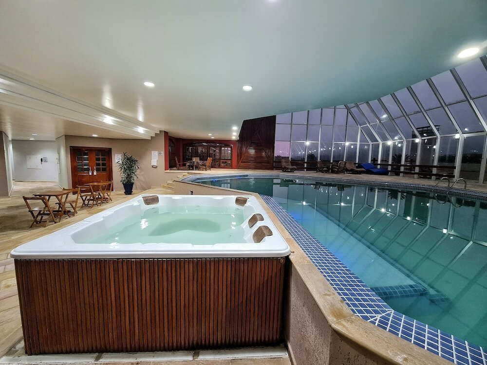 Фото Dúplex Luxo com Piscina Aquecida, Lareira e Wifi