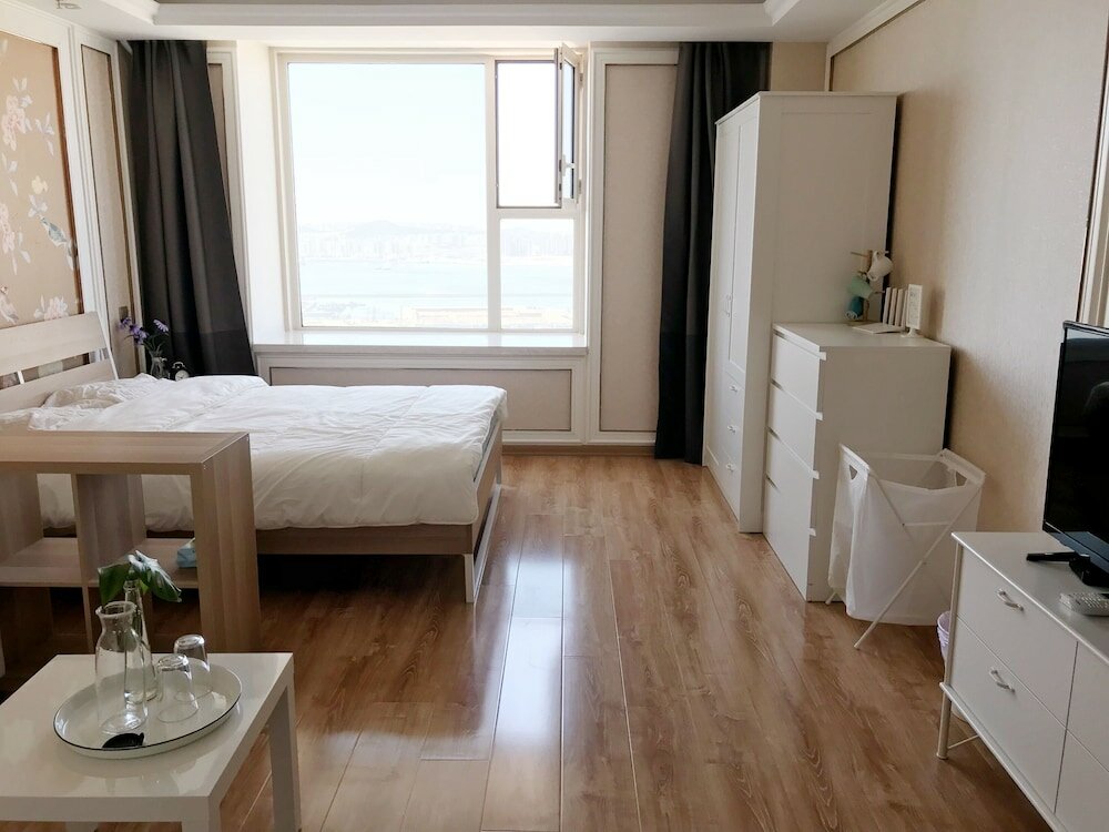 Фото Dalian Xuanya Apartment