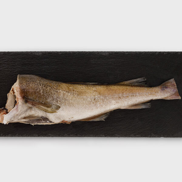 Треска потрошеная без головы замороженная