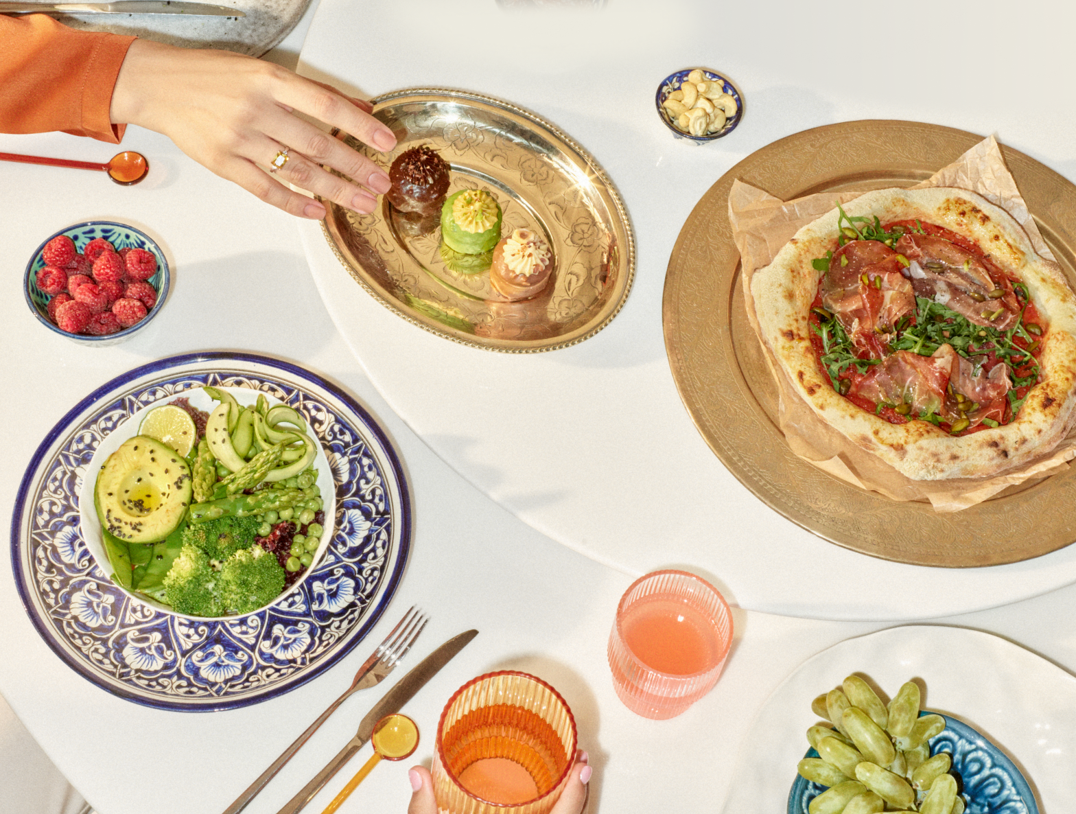 A dining table set with various dishes and cutlery