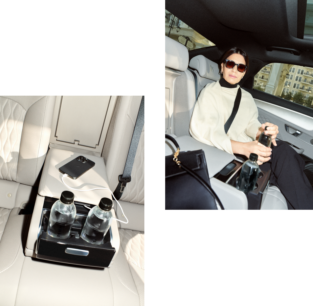 Interior of a comfortable car featuring water bottles, phone charger, music system, and air conditioning