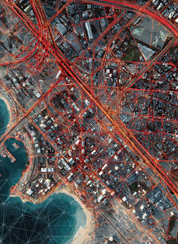 Aerial view of city with red road network lines, buildings, water bodies, and white grid overlay