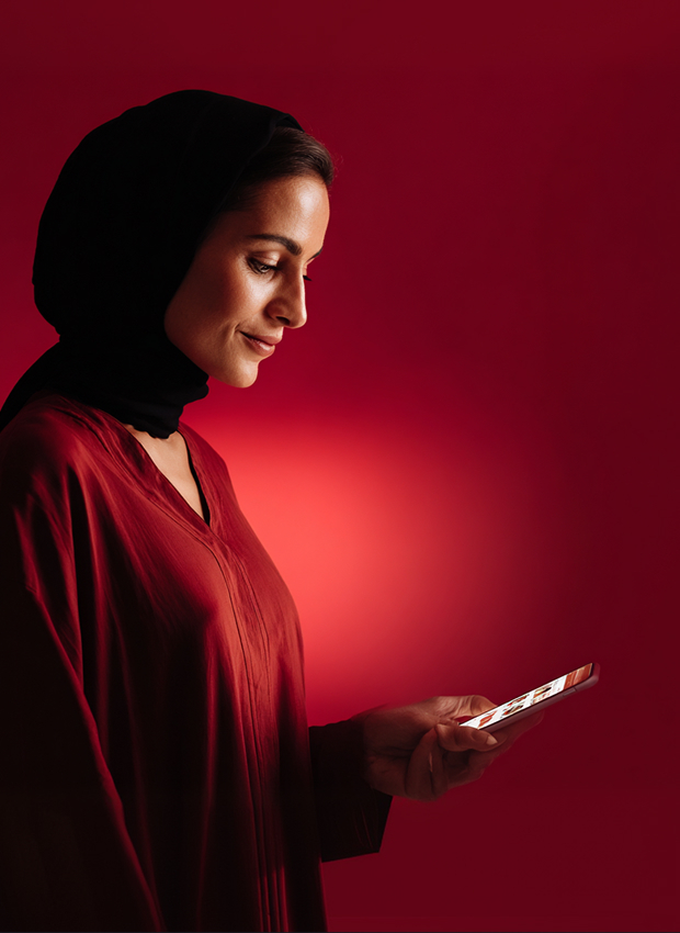 Woman in red dress holding smartphone