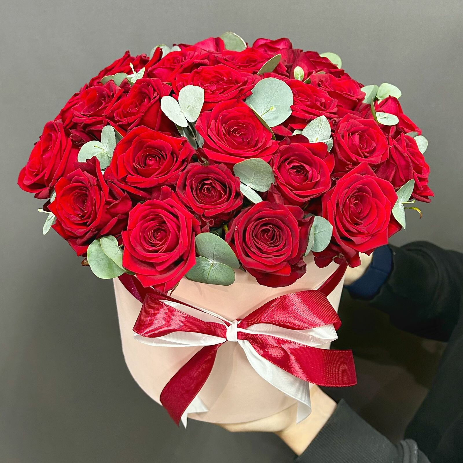 29 красных роз с эвкалиптом в шляпной коробке