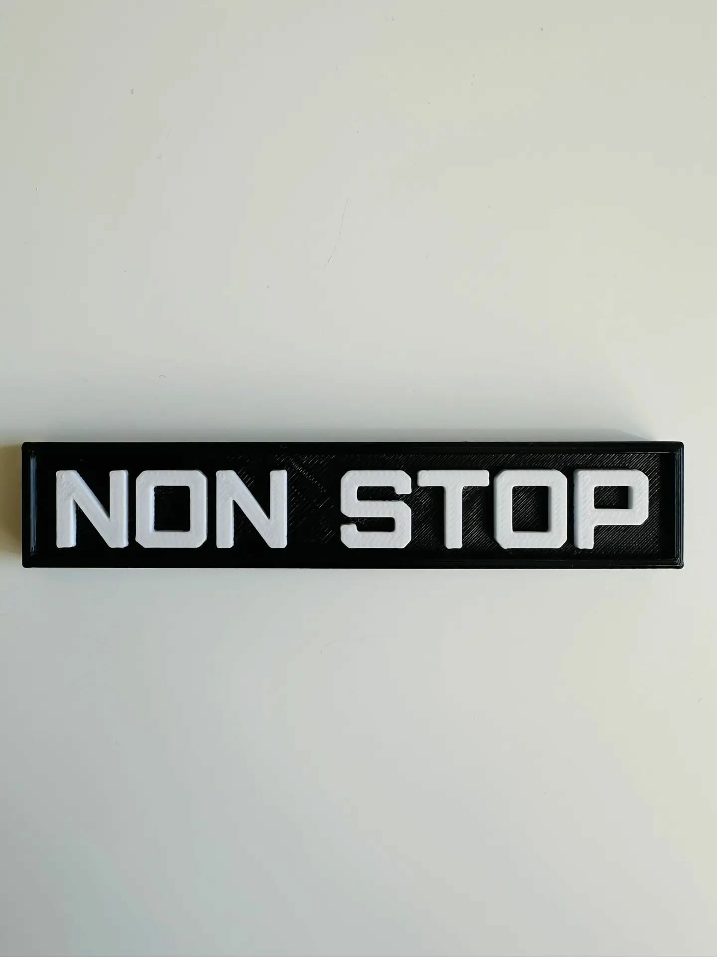 Шильдик NON STOP ( черно-белый ) 12х2,5см — фото 1