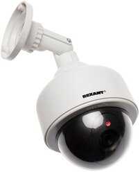 Муляж камеры видеонаблюдения Rexant 45-0200 Неотличим от обычной камеры. Мигающий красный светодиод (каждые 5 секунд) Питание: батарейки AА - 2шт. Мат