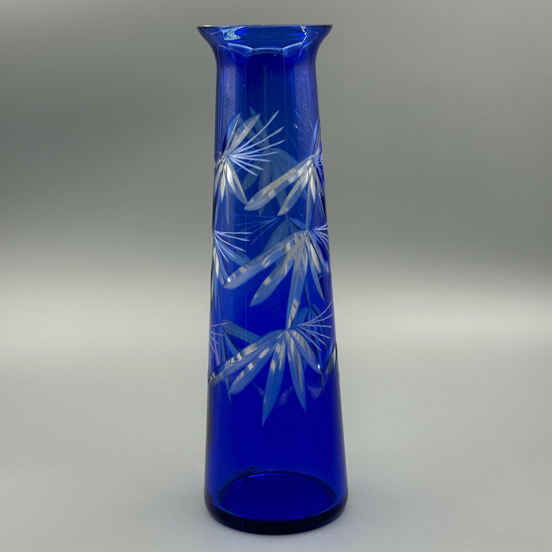 фото Ваза синего цвета конусообразной формы с расширенной горловиной и растительным декором