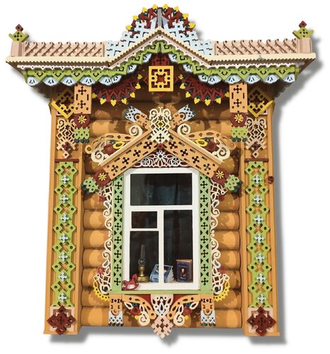 старинный деревянный оберег на стене дома