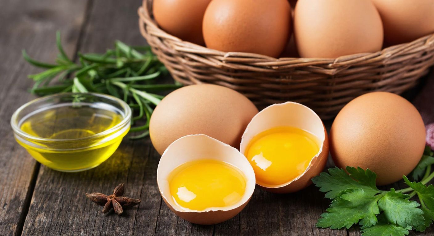 A rustic wooden table in a Turkish kitchen holds a basket of fresh brown eggs with a few cracked open to reveal bright yellow yolks, surrounded by fresh herbs and a small bowl of olive oil, evoking health and natural farming.
