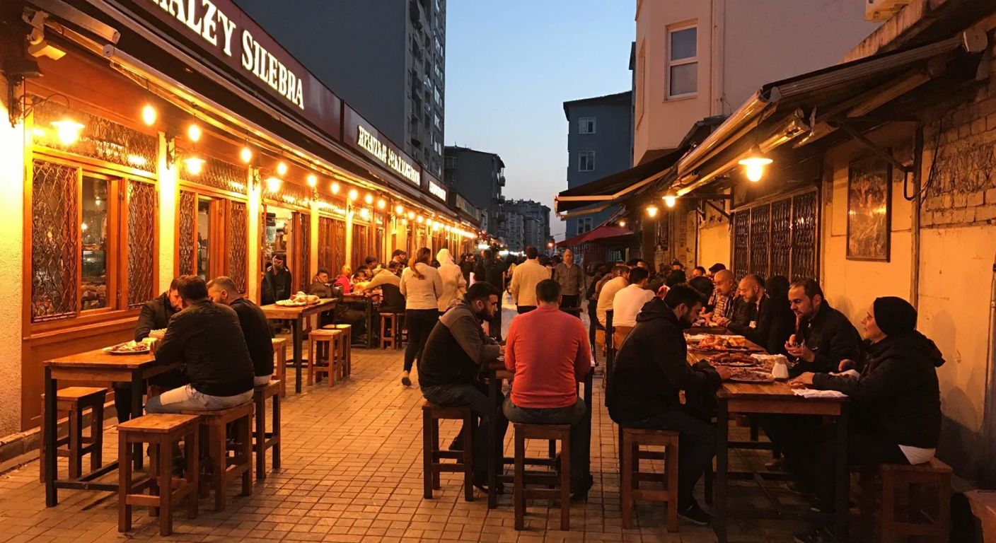A bustling street in Zeytinburnu, Istanbul, with a warmly lit traditional Turkish restaurant, people dining on wooden stools, and the aroma of grilled meats wafting through the air.