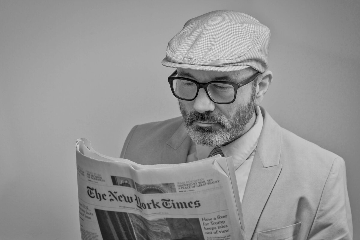 man reading newspaper фото