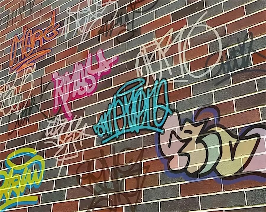 graffiti on a brick wall фото