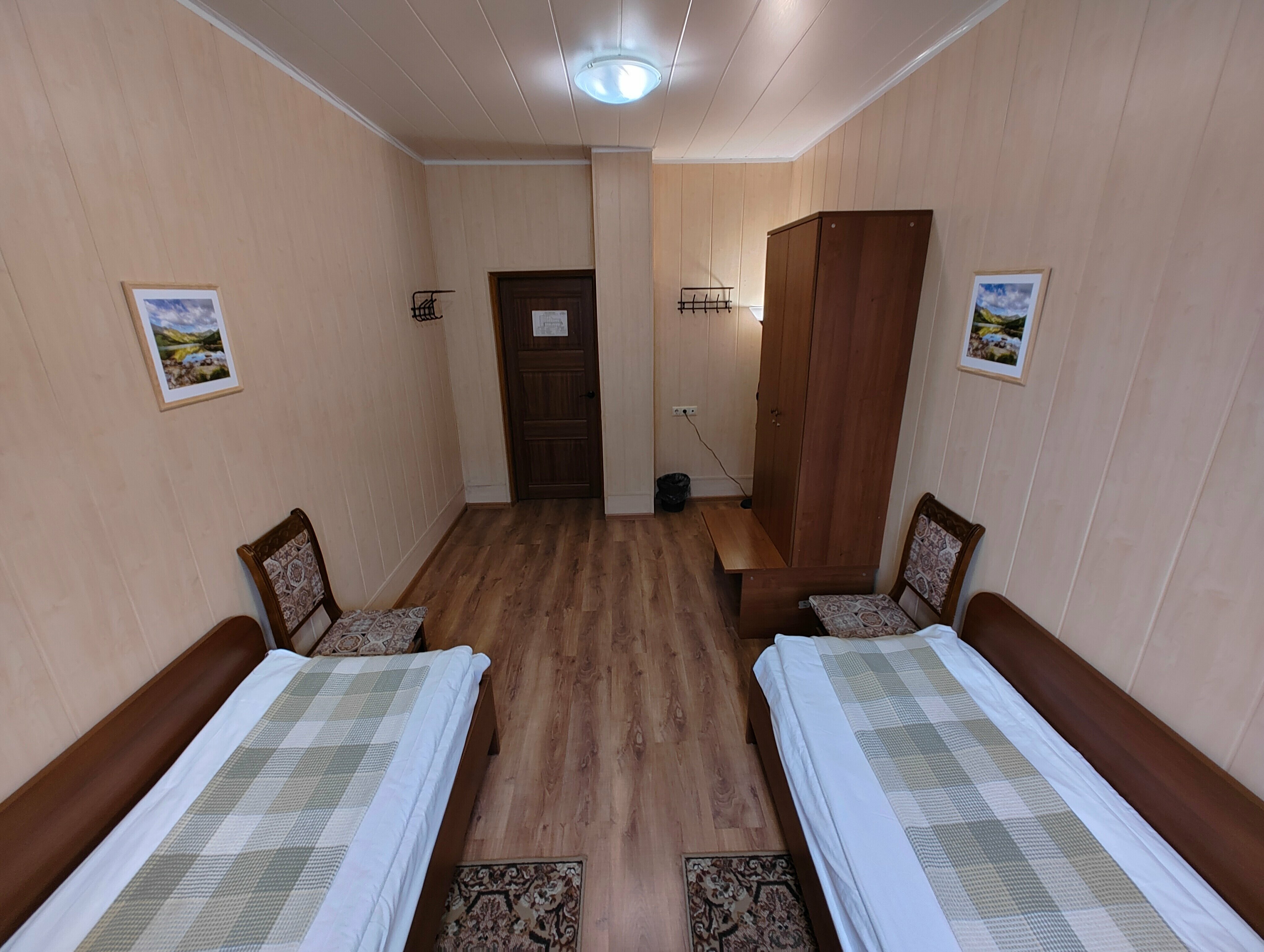 Односпальная кровать в общем номере для мужчин с общей ванной комнатой.