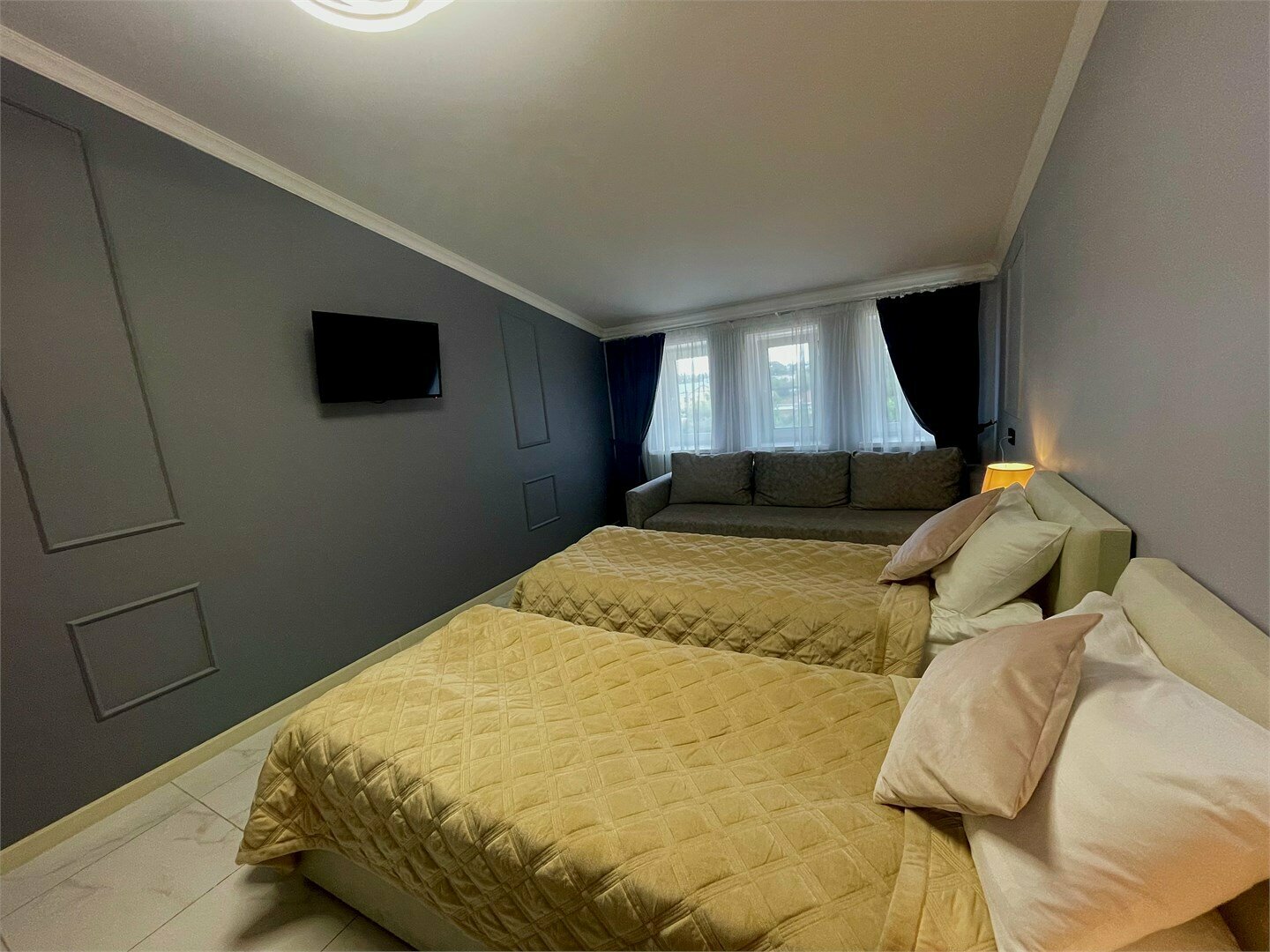 Стандартный номер с двумя односпальными кроватями и дополнительным двуспальным диваном