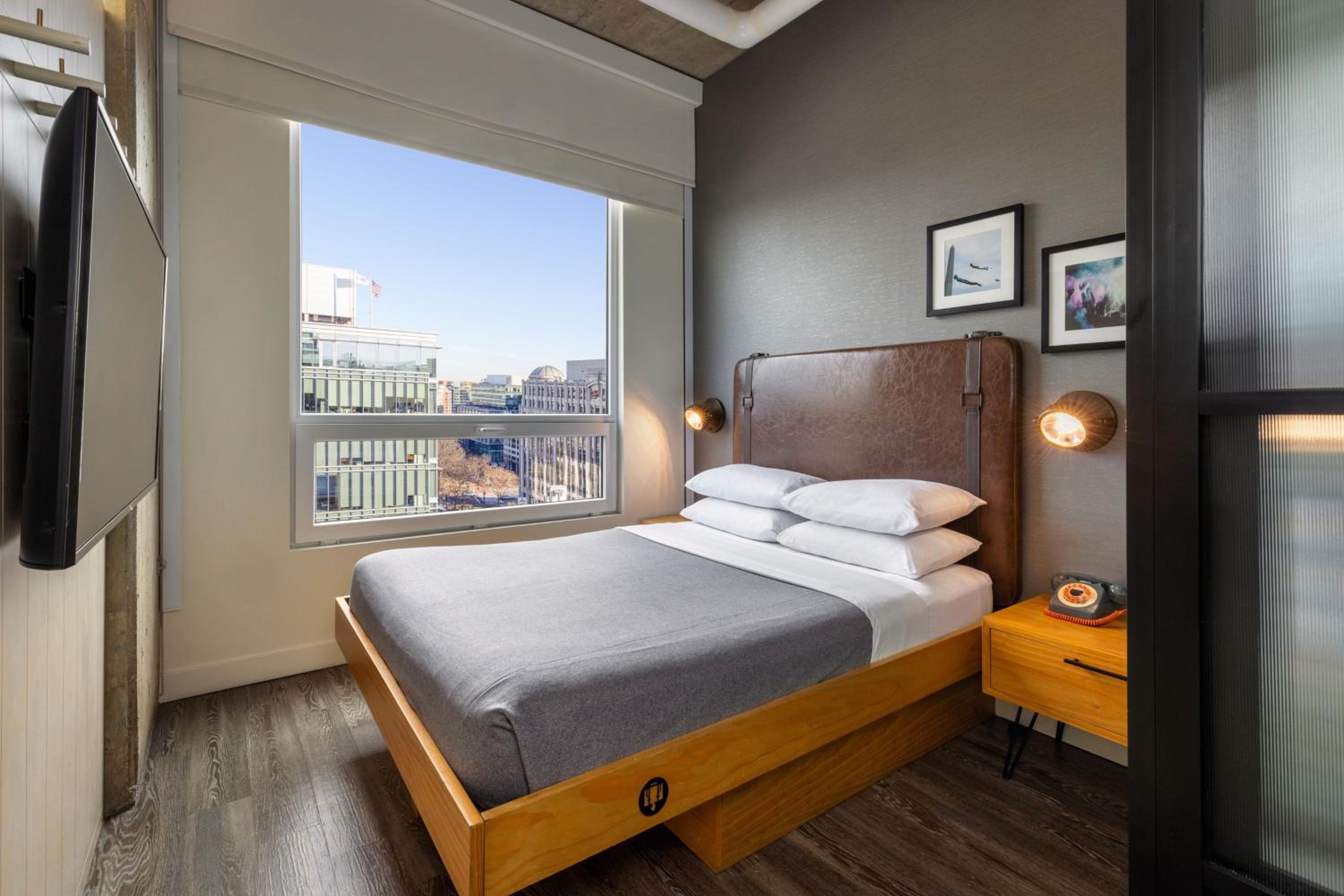 Guest room with queen bed and city view