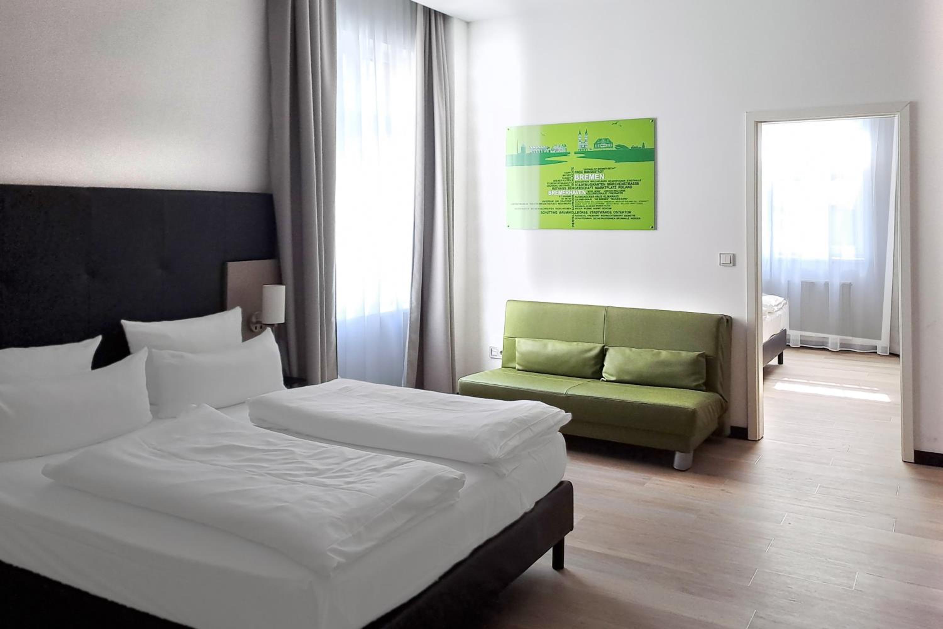 Premium Family Room with Two Queen Beds and Single Sofa Bed