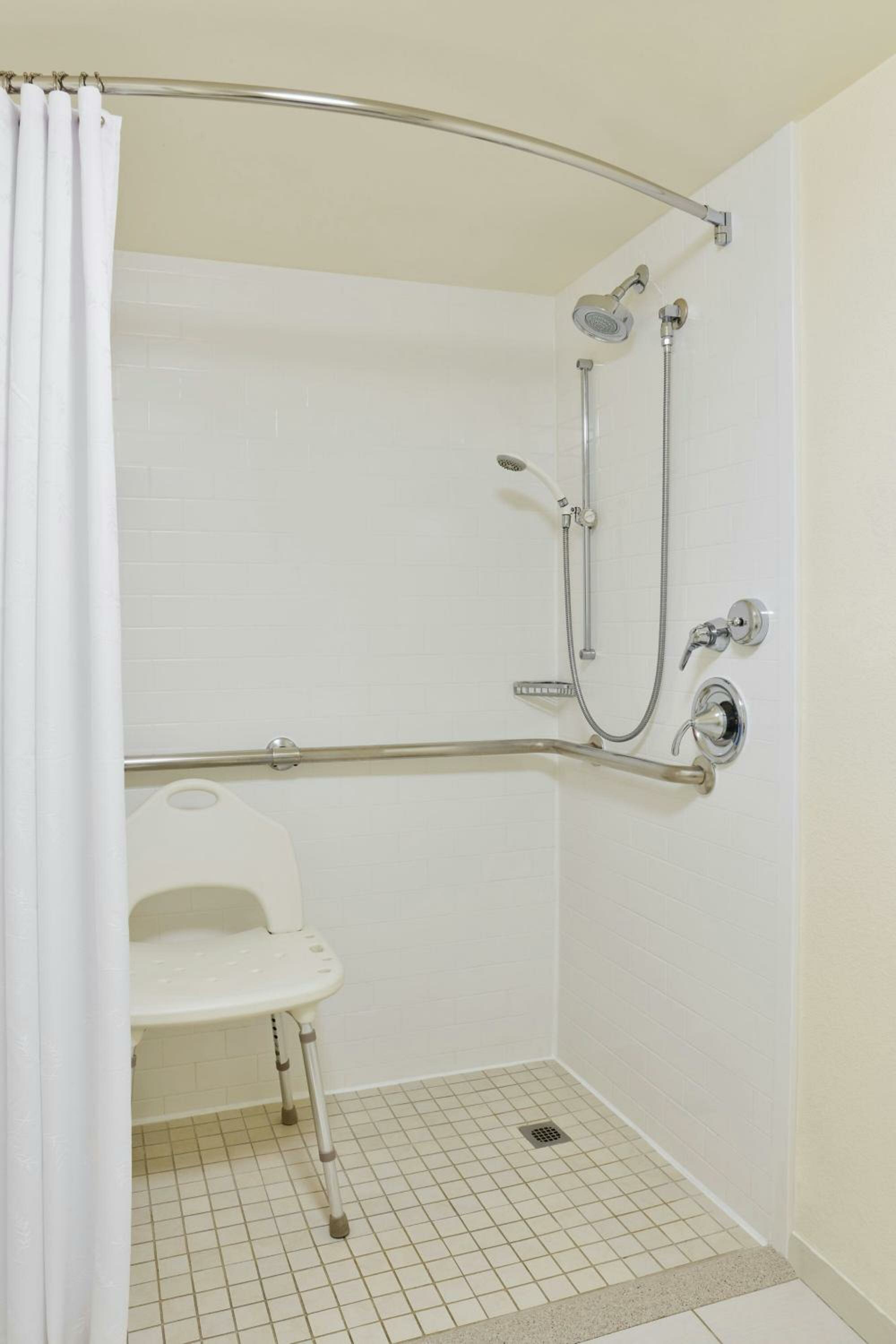 One-Bedroom King Suite with Sofa Bed and Pool View - Mobility Accessible with Roll-In Shower