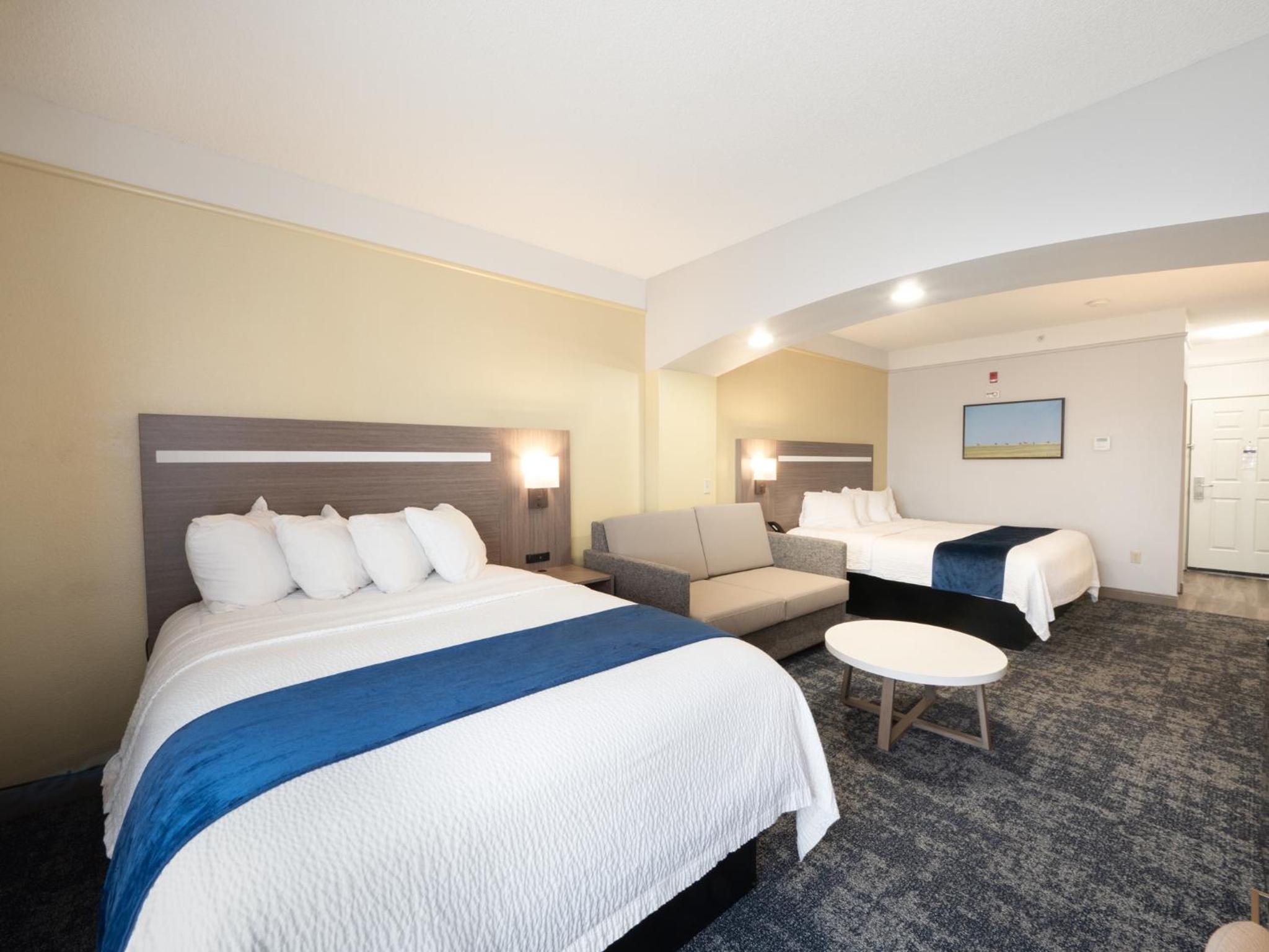 Larger Room with One King and One Queen Bed and Sofa - Non-Smoking