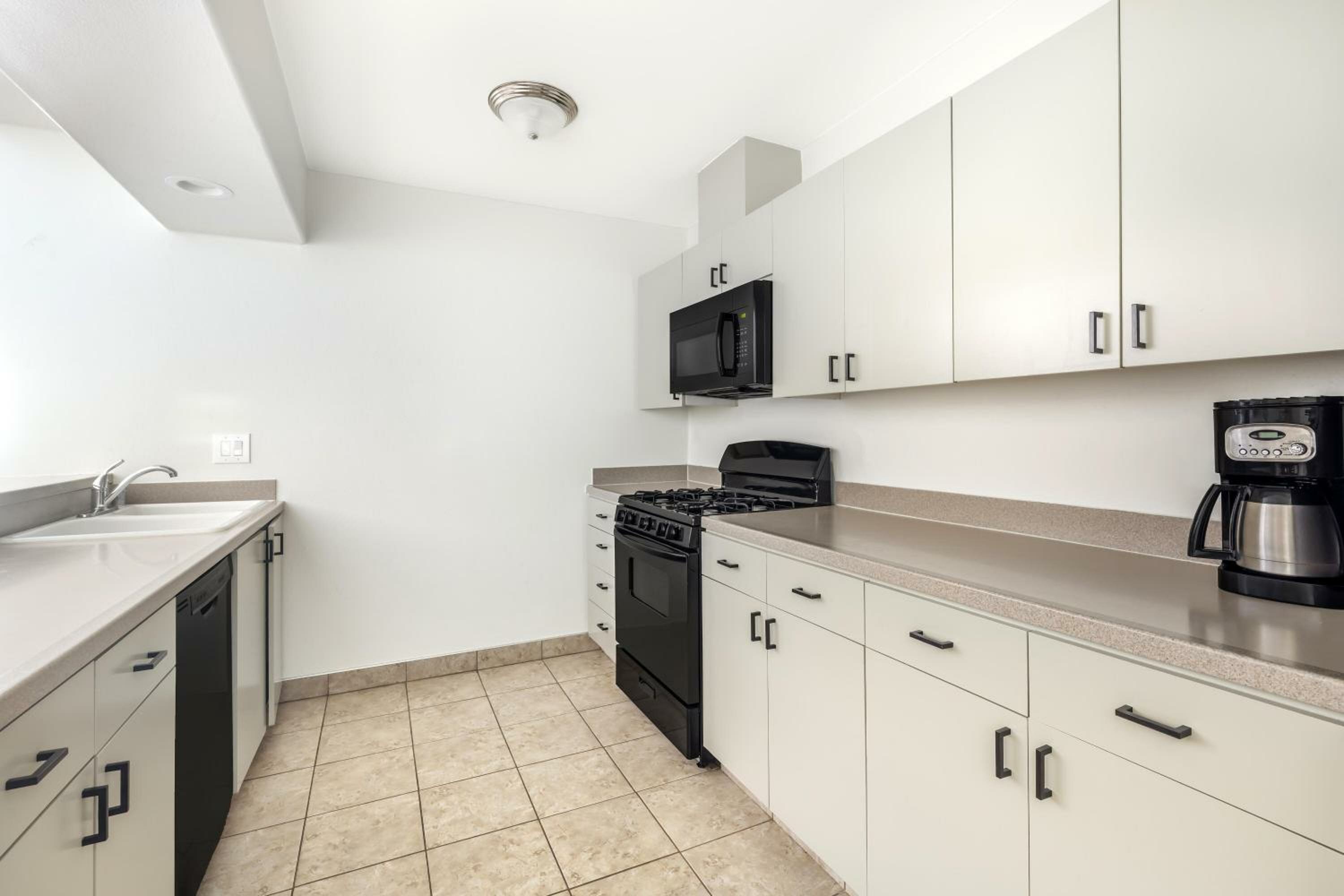 Two-Bedroom Suite with One King Bed, One Queen Bed, and Roll-In Shower