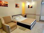 "Стандарт Оранжевый" с двуспальной кроватью, креслом и мини-кухней Парковая 29 в Номера Парк-Отель