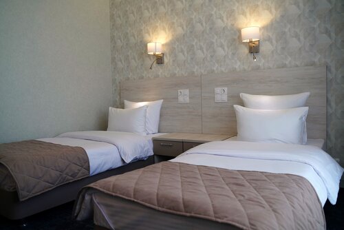 Стандартный двухместный номер с 2 отдельными кроватями и общей ванной комнатой в Арсеньево