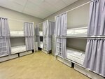 Спальное место на двухъярусной кровати в общем номере для мужчин в Сова