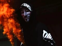 A man in an anonymous mask with a smoke bomb in his hand Desktop wallpapers 1600x1200