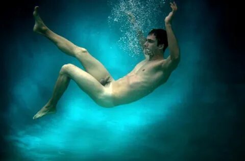 Nude male swimming.
