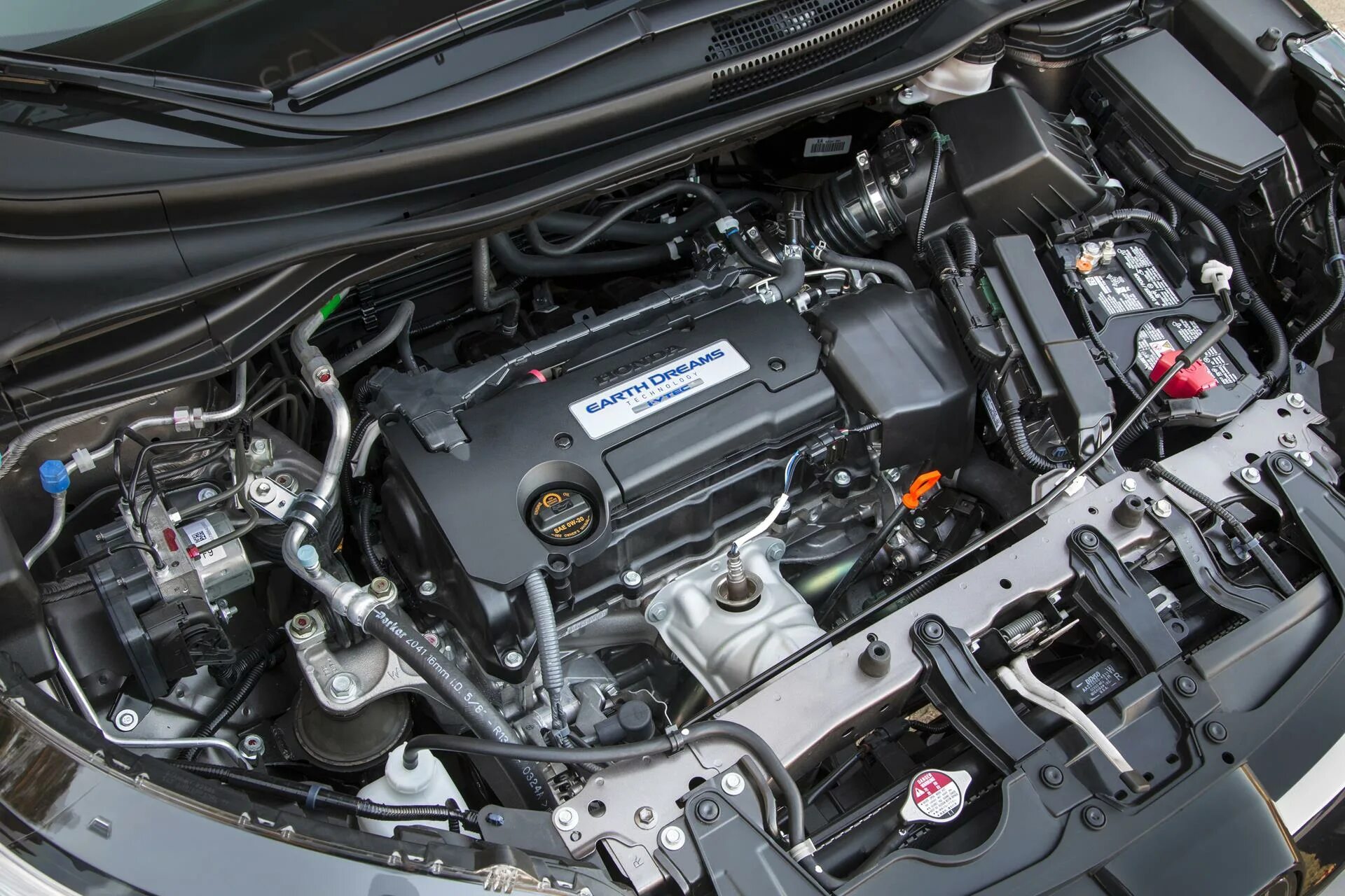 Двигатели хонда срв 2 поколения. Хонда СРВ 4 поколения 2.4 моторы. Honda CRV 2015 2.0 аккумулятор. CRV 2015 года АКБ 2,4. Хонда СРВ 2013 года 2,4 подкапотка.